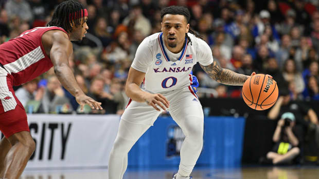 Mar 18, 2023; Des Moines, IA, USA; Kansas Jayhawks guard Bobby Pettiford Jr. (0) dribbles the ball against Arkansas Razorbacks guard Ricky Council IV (1) during the first half at Wells Fargo Arena. Mandatory Credit: Jeffrey Becker-USA TODAY Sports